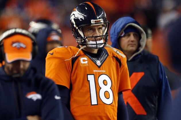 Denver Broncos quarterback Peyton Manning (18) watches the final seconds of an NFL divisional playoff football game against the Indianapolis Colts, Sunday, Jan. 11, 2015, in Denver. The Colts won 24-13 to advance to the AFC Championship game against the New England Patriots. (AP Photo/David Zalubowski)