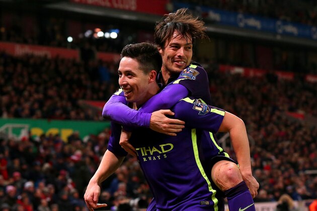 STOKE ON TRENT, ENGLAND - FEBRUARY 11:  Samir Nasri of Manchester City celebrates with team-mate David Silva of Manchester City after scoring his team's fourth goal during the Barclays Premier League match between Stoke City and Manchester City at Britannia Stadium on February 11, 2015 in Stoke on Trent, England.  (Photo by Alex Livesey/Getty Images)