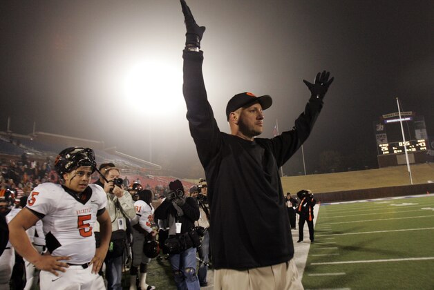 Gilmer head coach Jeff Traylor holds his hands up during the second half of the Texas High School UIL Class 3A Championship football game against Abilene Wylie in Dallas on Saturday, Dec. 12, 2009. Gilmer won 43-26. (AP Photo/Mike Fuentes)