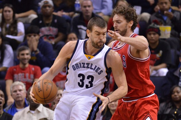 Memphis Grizzlies center Marc Gasol (33) drives against Chicago Bulls forward Pau Gasol in the first half of an NBA basketball game Friday, Dec. 19, 2014, in Memphis, Tenn. (AP Photo/Brandon Dill)