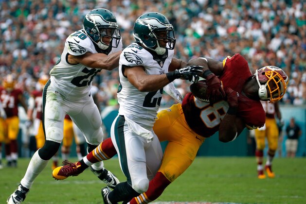Washington Redskins' Pierre Garcon, right,  is hit by Philadelphia Eagles' Nate Allen, center, and Cary Williams  during the second half of an NFL football game, Sunday, Sept. 21, 2014, in Philadelphia. (AP Photo/Matt Rourke)