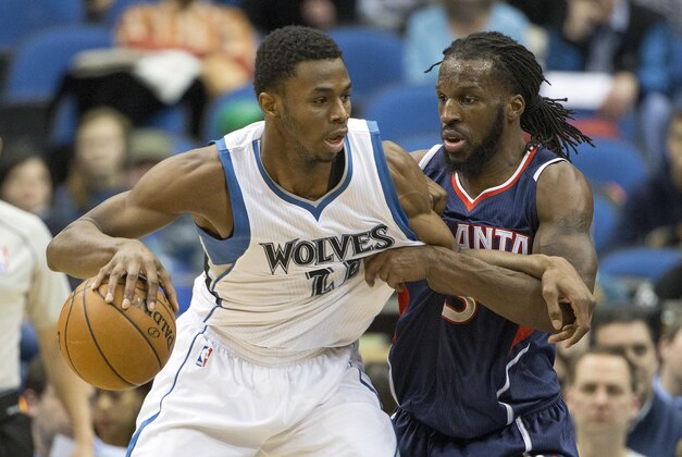 Feb 9, 2015; Minneapolis, MN, USA; Minnesota Timberwolves forward Andrew Wiggins (22) dribbles the ball past Atlanta Hawks forward DeMarre Carroll (5) in the second half at Target Center. The Hawks won 117-105. Mandatory Credit: Jesse Johnson-USA TODAY Sports