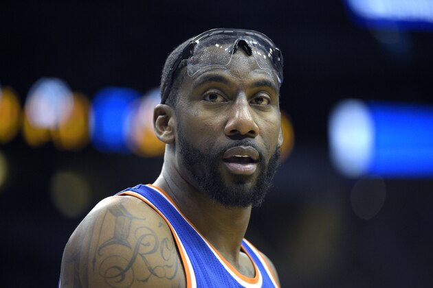 New York Knicks center Amar'e Stoudemire exchanges words with a fan sitting court side during the second half of an NBA basketball game against the Orlando Magic in Orlando, Fla., Wednesday, Feb. 11, 2015. The Magic won 89-83.(AP Photo/Phelan M. Ebenhack)