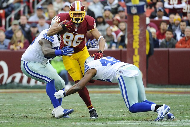 Dec 28, 2014; Landover, MD, USA; Washington Redskins tight end Jordan Reed (86) is tackled by Dallas Cowboys defensive tackle Henry Melton (left) and Dallas Cowboys strong safety Barry Church (42) during the first half at FedEx Field. Mandatory Credit: Brad Mills-USA TODAY Sports
