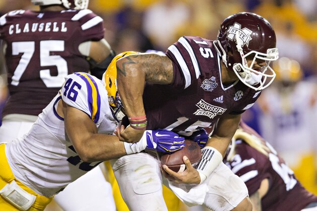 BATON ROUGE, LA - SEPTEMBER 20: Dak Prescott #15 of the Mississippi State Bulldogs is tackled from behind and almost stripped of the ball by Tashawn Bower #46 of the LSU Tigers at Tiger Stadium on September 20, 2014 in Baton Rouge, Louisiana.  The Bulldogs defeated the Tigers 34-29.  (Photo by Wesley Hitt/Getty Images)
