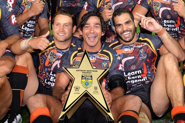 GOLD COAST, AUSTRALIA - FEBRUARY 13: Johnathan Thurston, Greg Inglis and Tyrone Roberts of the Indigenous All Stars celebrate victory after the NRL pre-season match between the Indigenous All Stars and the NRL All Stars at Cbus Super Stadium on February 13, 2015 in Gold Coast, Australia.  (Photo by Bradley Kanaris/Getty Images)