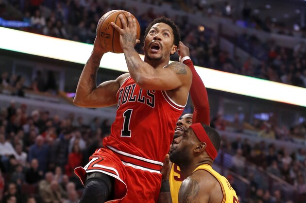 Chicago Bulls guard Derrick Rose (1) drives and scores past Cleveland Cavaliers' LeBron James during the second half of an NBA basketball game Thursday, Feb. 12, 2015, in Chicago. The Bulls won 113-98. (AP Photo/Charles Rex Arbogast)