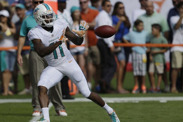 Miami Dolphins wide receiver Mike Wallace (11) catches the ball during practice before an NFL football game against the New York Jets, Sunday, Dec. 28, 2014, in Miami Gardens, Fla. (AP Photo/Wilfredo Lee)