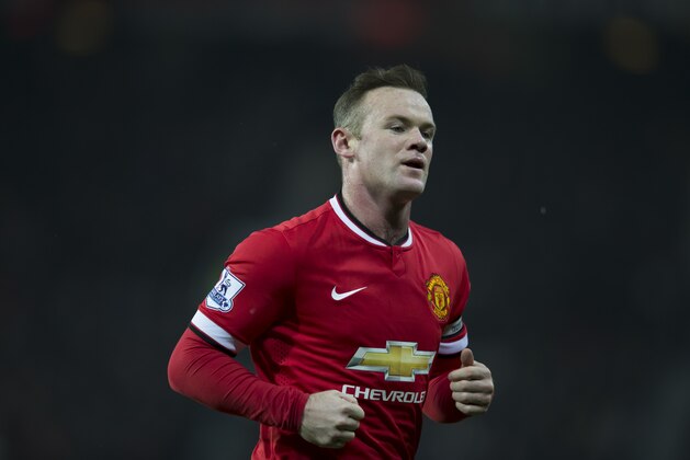 Manchester United's Wayne Rooney runs to take a corner during the English Premier League soccer match between Manchester United and Burnley at Old Trafford Stadium, Manchester, England, Wednesday Feb. 11, 2015. (AP Photo/Jon Super)