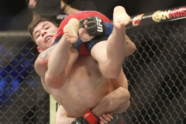 Dustin Ortiz and Ray Borg, left, fight in a mixed martial arts event on Saturday, April 19, 2014, at UFC Fight Night in Orlando Fla.. Ortiz won. (AP Photo/Reinhold Matay)