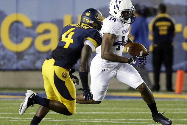 Northwestern's Christian Jones, right, runs past California's Avery Sebastian (4) during the first half of an NCAA college football game on Saturday, Aug. 31, 2013, in Berkeley, Calif. (AP Photo/Ben Margot)