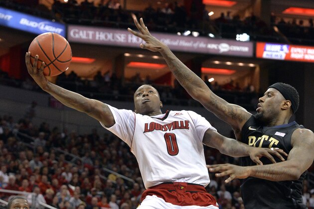 Louisville's Terry Rozier, left, goes in for a layup past the defense of Pittsburgh's Jamel Artis during the second half of an NCAA college basketball game Wednesday, Feb. 11, 2015 in Louisville, Ky. Louisville won 69-56. (AP Photo/Timothy D. Easley)
