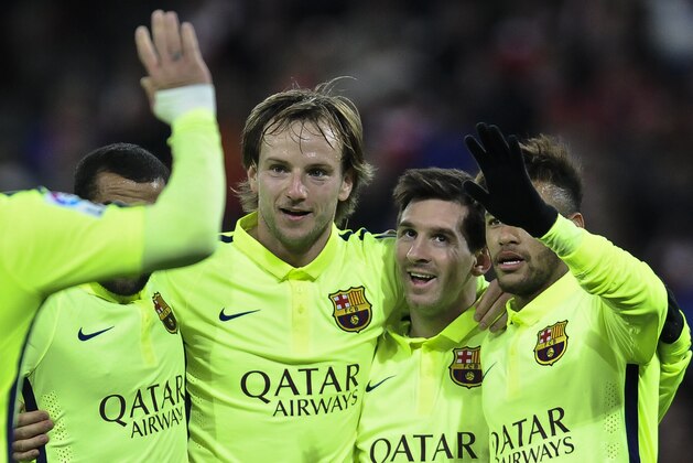 FC Barcelona's Lionel Messi of Argentina, second right, celebrates scoring his second and the fifth goal  of the match against Athletic Bilbao with teammates during their La Liga soccer match, at San Mames stadium in Bilbao, northern Spain, Sunday, Feb. 8, 2015. (AP Photo/Alvaro Barrientos)
