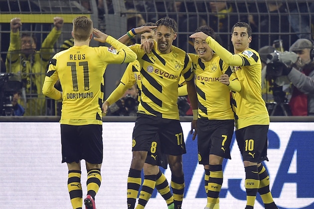 Dortmund's Marco Reus, left, salutes scorer Pierre-Emerick Aubameyang from Gabun after he scored the 3-2 during the German Bundesliga soccer match between Borussia Dortmund and FSV Mainz in Dortmund, Germany, Friday, Feb. 13, 2015. (AP Photo/Martin Meissner)