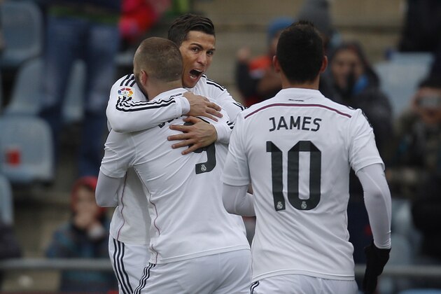 Real Madrid's Cristiano Ronaldo, centre, celebrates his goal with team mates during a Spanish La Liga soccer match between Getafe and Real Madrid at the Coliseum Alfonso Perez stadium in Madrid, Spain, Sunday, Jan. 18, 2015. (AP Photo/Andres Kudacki)