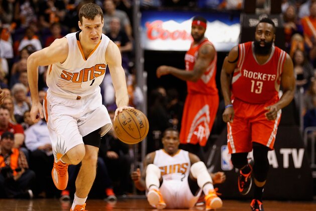 PHOENIX, AZ - FEBRUARY 10:  Goran Dragic #1 of the Phoenix Suns moves the ball upcourt after a turnover from James Harden #13 of the Houston Rockets during the second half of the NBA game at US Airways Center on February 10, 2015 in Phoenix, Arizona. The Rockets defeated the Suns 127-118.  NOTE TO USER: User expressly acknowledges and agrees that, by downloading and or using this photograph, User is consenting to the terms and conditions of the Getty Images License Agreement.  (Photo by Christian Petersen/Getty Images)
