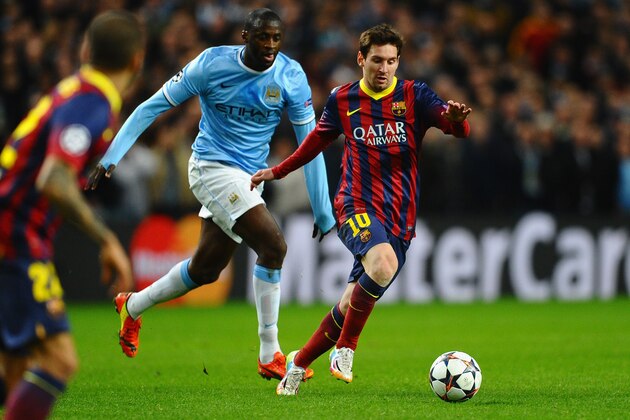 MANCHESTER, ENGLAND - FEBRUARY 18:  Lionel Messi of Barcelona competes with Yaya Toure of Manchester City during the UEFA Champions League Round of 16 first leg match between Manchester City and Barcelona at the Etihad Stadium on February 18, 2014 in Manchester, England.  (Photo by Laurence Griffiths/Getty Images)