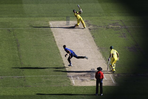 MELBOURNE, AUSTRALIA - FEBRUARY 14:  Glenn Maxwell of Australia hits down the ground off the bowling of Steven Finn of England during the 2015 ICC Cricket World Cup match between England and Australia at Melbourne Cricket Ground on February 14, 2015 in Melbourne, Australia.  (Photo by Ryan Pierse/Getty Images)