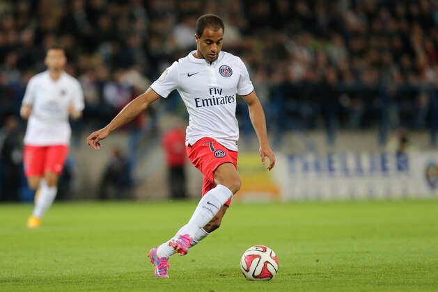 Paris Saint Germain's forward Lucas Moura of Brazil run with the ball on the field during his League One soccer match against Caen, in Caen, western France, Wednesday, Sept. 24, 2014. (AP Photo/David Vincent)