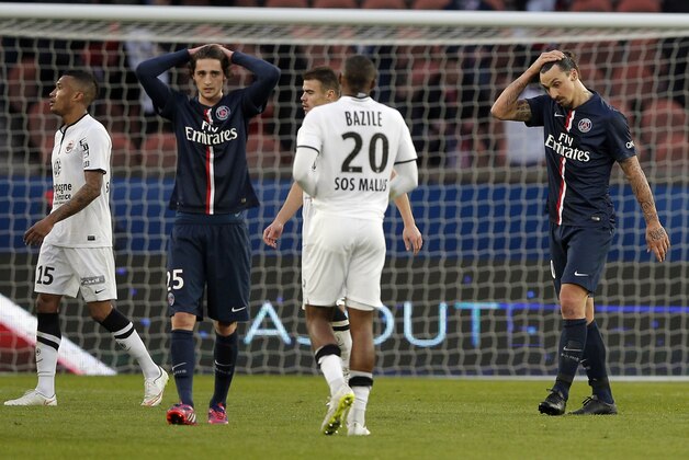 Paris St Germain's Zlatan Ibrahimovic, right, and Paris St Germain's Adrien Rabiot, second left,  react, at the end of the French league one soccer match between PSG and Caen, in Paris, France, Saturday, Feb. 14, 2015. The match ended in a draw 2-2.  (AP Photo/Christophe Ena)