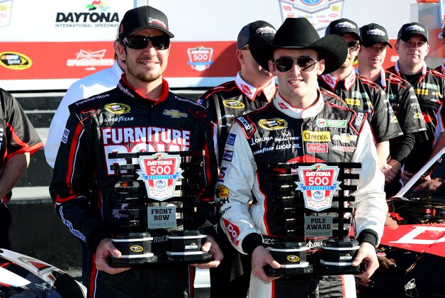 Feb 16, 2014; Daytona Beach, FL, USA; NASCAR Sprint Cup Series driver Martin Truex Jr. (left) and NASCAR Sprint Cup Series driver Austin Dillon (right) celebrate starting on the front row for the Daytona 500 at Daytona International Speedway. Mandatory Credit: Jasen Vinlove-USA TODAY Sports