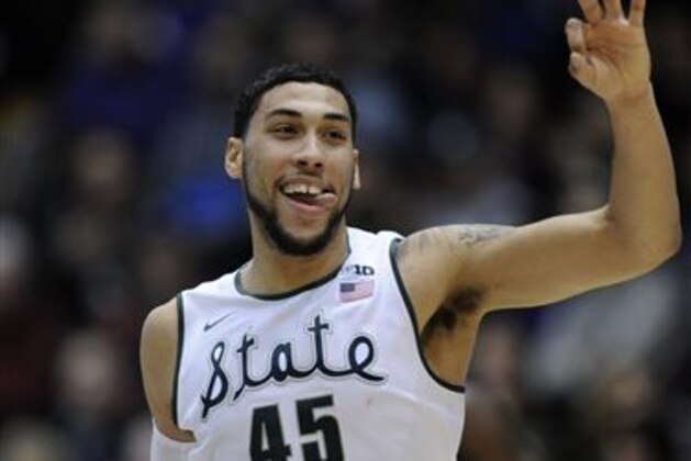Michigan State's Denzel Valentine celebrates after making a 3-point basket during the first half of an NCAA college basketball game against Northwestern in Evanston, Ill., Tuesday, Feb. 10, 2015. (AP Photo/Paul Beaty)