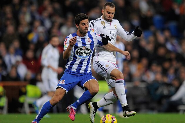 MADRID, SPAIN - FEBRUARY 15:  Jese Rodriguez of Real Madrid tackles Juan Dominguez of RC Deportivo La Coruna during the La Liga match between Real Madrid CF and RC Deportivo La Coruna at Estadio Santiago Bernabeu on February 15, 2015 in Madrid, Spain.  (Photo by Denis Doyle/Getty Images)
