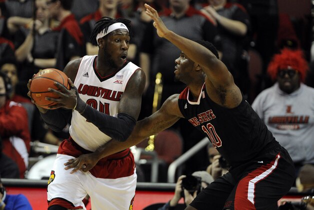 Feb 14, 2015; Louisville, KY, USA; Louisville Cardinals forward Montrezl Harrell (24) posts up against North Carolina State Wolfpack forward Lennard Freeman (10) during the first half at KFC Yum! Center. Mandatory Credit: Jamie Rhodes-USA TODAY Sports