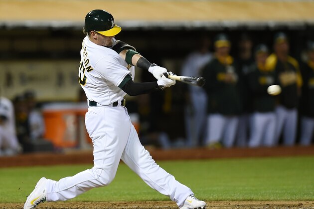 OAKLAND, CA - JULY 07:  Josh Donaldson #20 of the Oakland Athletics hits an RBI single, scoring Yoenis Cespedes (not pictured) in the bottom of the seventh inning against the San Francisco Giants at O.co Coliseum on July 7, 2014 in Oakland, California.  (Photo by Thearon W. Henderson/Getty Images)