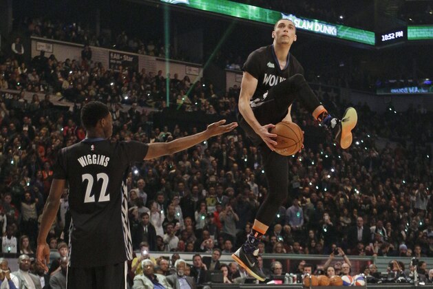 Minnesota Timberwolves' Zach LaVine, right, takes the ball from teammate Andrew Wiggins as he competes during the NBA All-Star Saturday Slam Dunk basketball contest Saturday, Feb. 14, 2015, in New York. (AP Photo/Frank Franklin II)