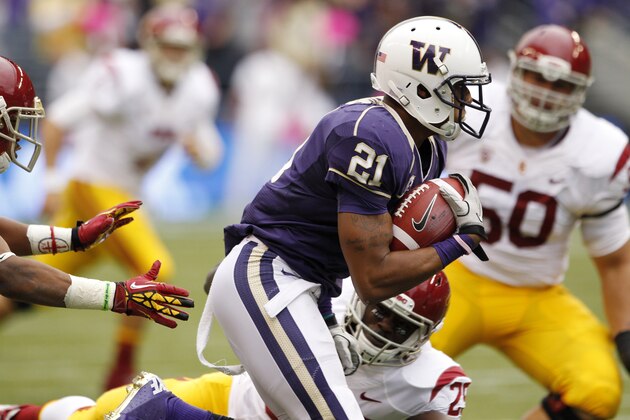 Washington's Marcus Peters (21) runs with an interception of a Southern California pass during the first half of an NCAA college football game Saturday, Oct. 13, 2012, in Seattle. (AP Photo/Elaine Thompson)