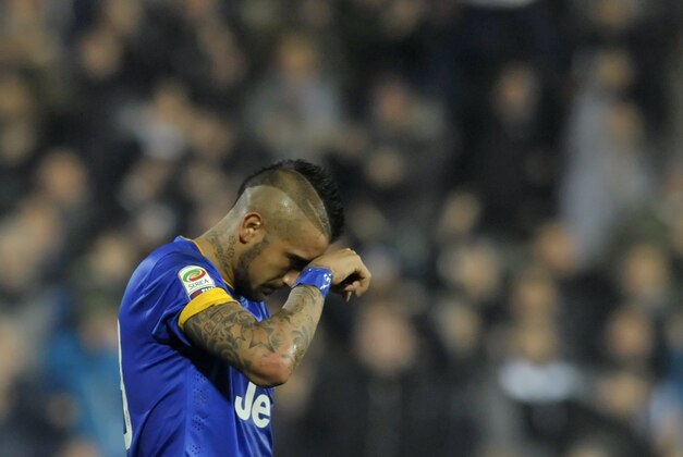 Juventus' Arturo Vidal touches his face after missing a chance to score on penalty kick against Cesena during a Serie A soccer match at Cesena's Manuzzi stadium, Italy, Sunday, Feb. 15, 2015. (AP Photo/Marco Vasini)