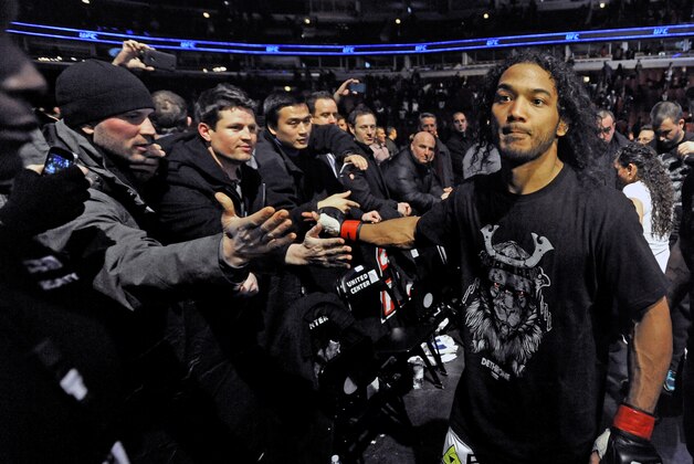 Benson Henderson celebrates with fans after defeating Josh Thomson during the main event of the UFC mixed martial arts match in Chicago, Saturday, Jan., 25, 2014. (AP Photo/Paul Beaty)