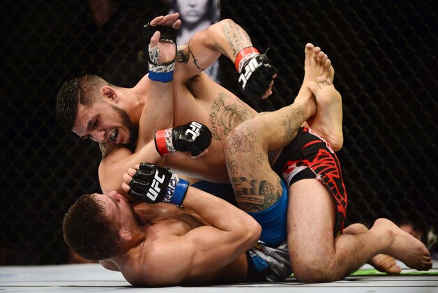 Feb 14, 2015; Broomfield, CO, USA; Rodrigo De Lima (blue) and Efrain Escudero (red) compete during UFC Fight Night at the 1stBANK Center. Mandatory Credit: Ron Chenoy-USA TODAY Sports