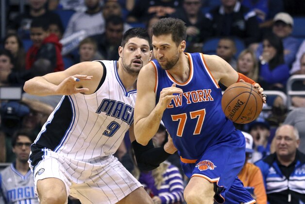 Feb 11, 2015; Orlando, FL, USA; Orlando Magic center Nikola Vucevic (9) defends against the driving New York Knicks center Andrea Bargnani (77) during the fourth quarter of an NBA basketball game at Amway Center. The Magic won 89-83. Mandatory Credit: Reinhold Matay-USA TODAY Sports