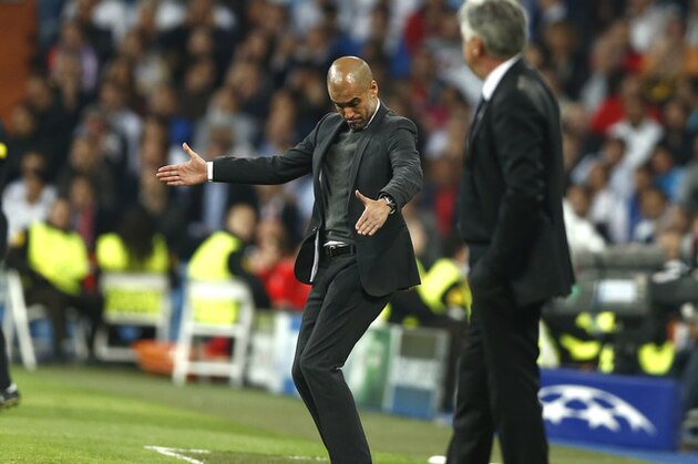 Bayern head coach Pep Guardiola, left, gestures to his players next to Real's coach Carlo Ancelotti during a first leg semifinal Champions League soccer match between Real Madrid and Bayern Munich at the Santiago Bernabeu stadium in Madrid, Spain, Wednesday, April 23, 2014. (AP Photo/Andres Kudacki)