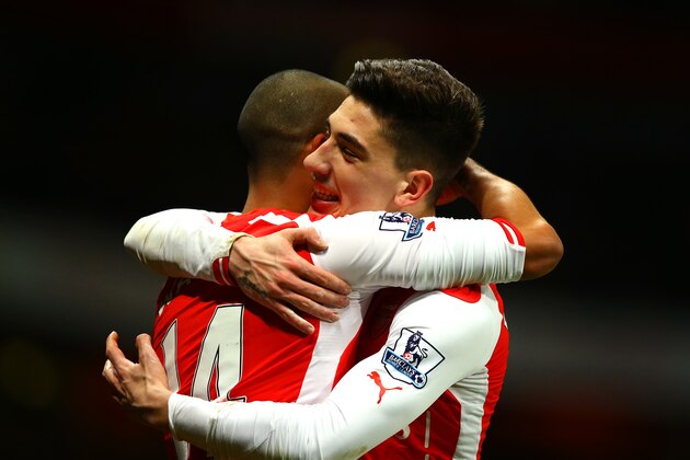 LONDON, ENGLAND - FEBRUARY 10:  Theo Walcott of Arsenal celebrates with team-mate Hector Bellerin after scoring his team's second goal during the Barclays Premier League match between Arsenal and Leicester City at Emirates Stadium on February 10, 2015 in London, England.  (Photo by Richard Heathcote/Getty Images)