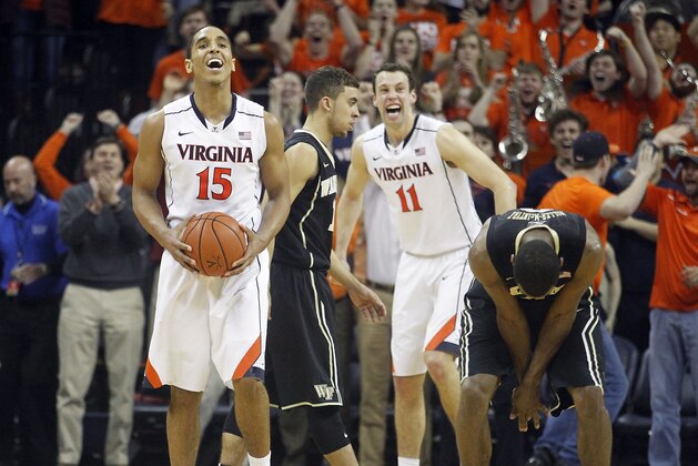 Virginia guard Malcolm Brogdon (15) holds the ball while Wake Forest guard Codi Miller-McIntyre (0) doubles over as time expires during the second half of an NCAA college basketball game at John Paul Jones Arena in Charlottesville, Va., on Saturday, Feb. 14, 2015. Virginia won 61-60. (AP Photo/Ryan M. Kelly)