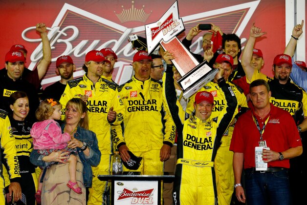 DAYTONA BEACH, FL - FEBRUARY 20:  Matt Kenseth, driver of the #20 Dollar General Toyota, celebrates in Victory Lane after winning the NASCAR Sprint Cup Series Budweiser Duel 1 at Daytona International Speedway on February 20, 2014 in Daytona Beach, Florida.  (Photo by Tom Pennington/Getty Images)