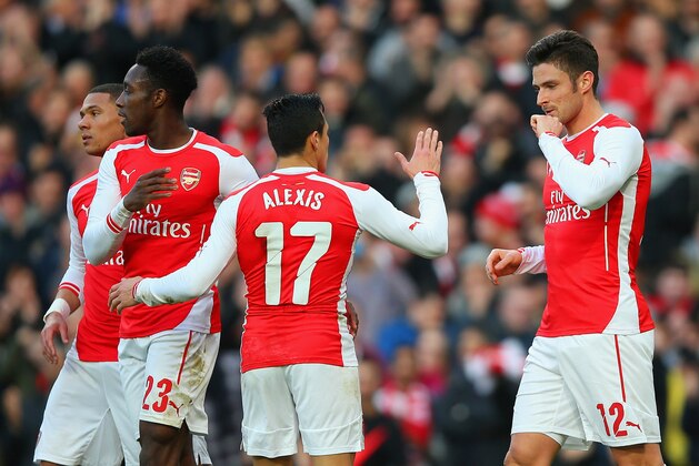 LONDON, ENGLAND - FEBRUARY 15:  Olivier Giroud of Arsenal (R) celebrates with Alexis Sanchez and Danny Welbeck of Arsenal after scoring the opening goal during the FA Cup fifth round match between Arsenal and Middlesbrough at Emirates Stadium on February 15, 2015 in London, England.  (Photo by Paul Gilham/Getty Images)