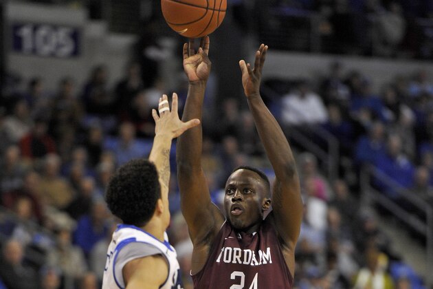 Jan 18, 2014; St. Louis, MO, USA; Fordham Rams guard Bryan Smith (24) shoots the ball while being guarded by Saint Louis Billikens guard Austin McBroom (2) during the second half at Chaifetz Arena. The Saint Louis Billikens defeat the Fordham Rams 70-48. Mandatory Credit: Jasen Vinlove-USA TODAY Sports