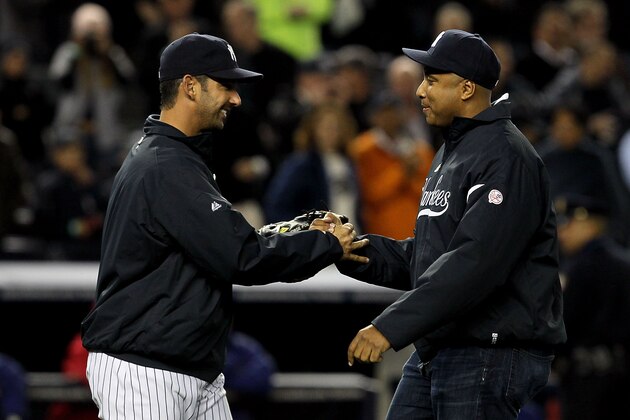 NEW YORK - OCTOBER 19:  Former New York Yankee Bernie Williams greets Jorge Posada #20 after throwing out the first pitch prior to Game Four of the ALCS during the 2010 MLB Playoffs at Yankee Stadium on October 19, 2010 in the Bronx borough of New York City.  (Photo by Jim McIsaac/Getty Images)