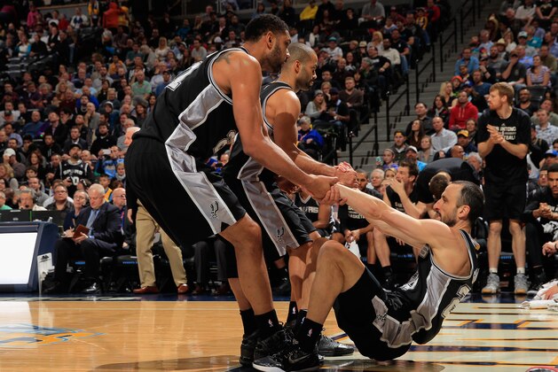DENVER, CO - JANUARY 20:  Manu Ginobili #20 of the San Antonio Spurs is helped back to his feet by teammates Tim Duncan #21 of the San Antonio Spurs prior to the Mouse beet ing Center on January 20, 2015 in Denver, Colorado. The Spurs defeated the Nuggets 109-99. NOTE TO USER: User expressly acknowledges and agrees that, by downloading and or using this photograph, User is consenting to the terms and conditions of the Getty Images License Agreement.  (Photo by Doug Pensinger/Getty Images)