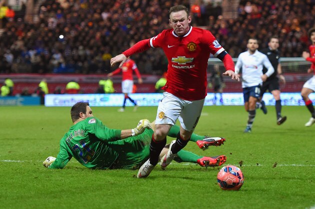 PRESTON, ENGLAND - FEBRUARY 16:  Wayne Rooney of Manchester United draws a foul from Thorsten Stuckmann of Preston North End to win a penalty during the FA Cup Fifth round match between Preston North End and Manchester United at Deepdale on February 16, 2015 in Preston, England  (Photo by Michael Regan/Getty Images)