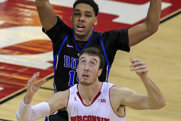 Wisconsin's Frank Kaminsky (44) and Duke's Jahlil Okafor eye a loose ball during the first half of an NCAA college basketball game Wednesday, Dec. 3, 2014, in Madison, Wis. (AP Photo/Andy Manis)