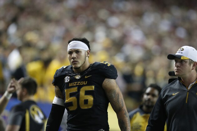 Missouri defensive lineman Shane Ray (56) walks off the field after being ejected from the game for a late hit against Alabama quarterback Blake Sims during the first half of the Southeastern Conference championship NCAA college football game, Saturday, Dec. 6, 2014, in Atlanta. (AP Photo/Brynn Anderson)