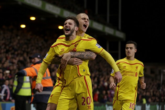 Liverpool's Adam Lallana, front, celebrates scoring his side's second goal with Martin Skrtel, center, and Philippe Coutinho during the English FA Cup fifth round soccer match between Crystal Palace and Liverpool at Selhurst Park stadium in London, Saturday, Feb. 14, 2015.  (AP Photo/Matt Dunham)