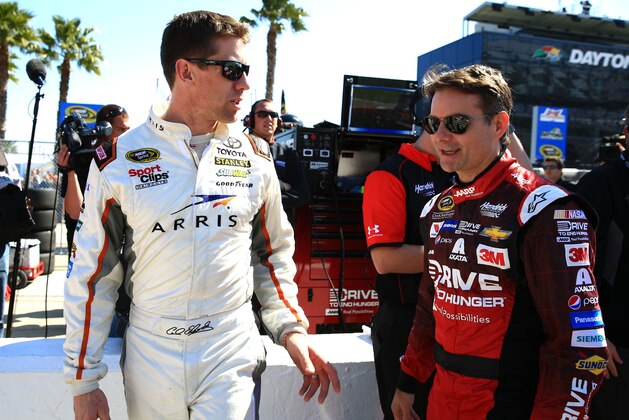 Feb 15, 2015; Daytona Beach, FL, USA; NASCAR Sprint Cup Series driver Carl Edwards (19) talks with Jeff Gordon (24) during Daytona 500 Qualifying at Daytona International Speedway. Mandatory Credit: Andrew Weber-USA TODAY Sports