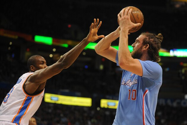 Feb 8, 2015; Oklahoma City, OK, USA; Los Angeles Clippers forward Spencer Hawes (10) shoots the ball as Oklahoma City Thunder forward Serge Ibaka (9) defends during the second quarter at Chesapeake Energy Arena. Mandatory Credit: Mark D. Smith-USA TODAY Sports