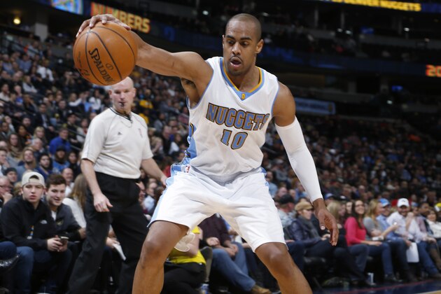 Denver Nuggets guard Arron Afflalo reaches out to save the ball from going out of play as referee Gary Zielinski watches, during the third quarter of the Nuggets' NBA basketball game against the Orlando Magic on Wednesday, Jan. 7, 2015, in Denver. The Nuggets defeated the Magic 93-90. (AP Photo/David Zalubowski)